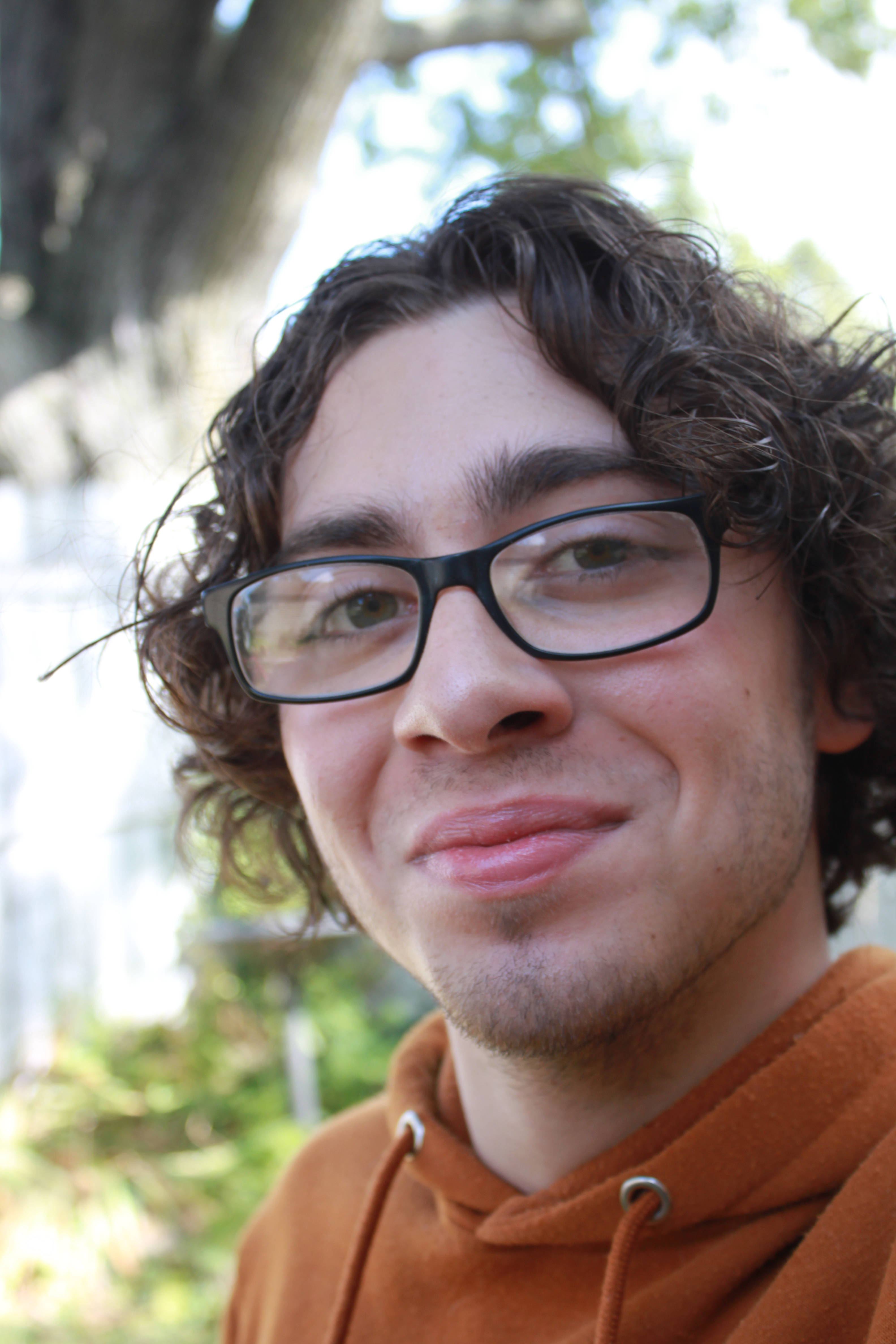 Picture of Ty Eggers with glasses in front of a blurry background.